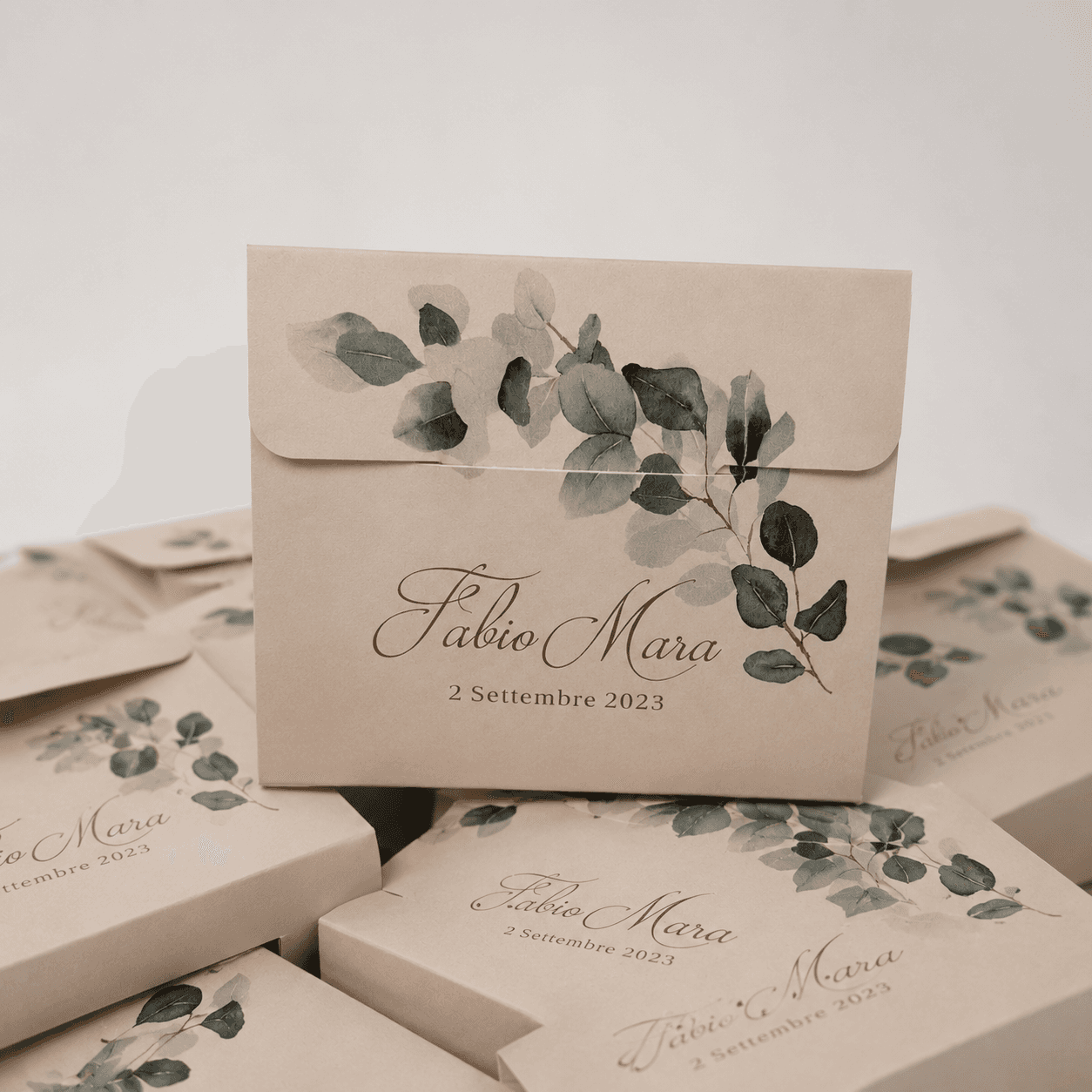 Scatole bomboniera in carta kraft con stampa a rametti di eucalipto, esempio di packaging matrimonio
